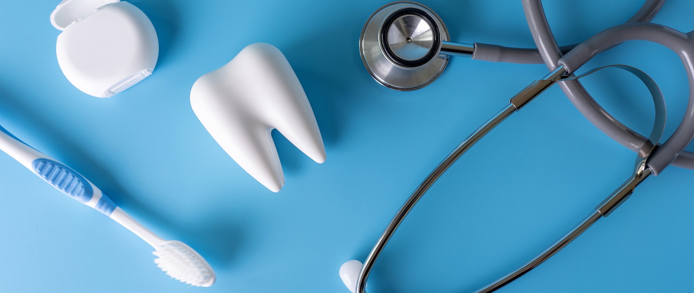Dental equipment spread in front of a blue background