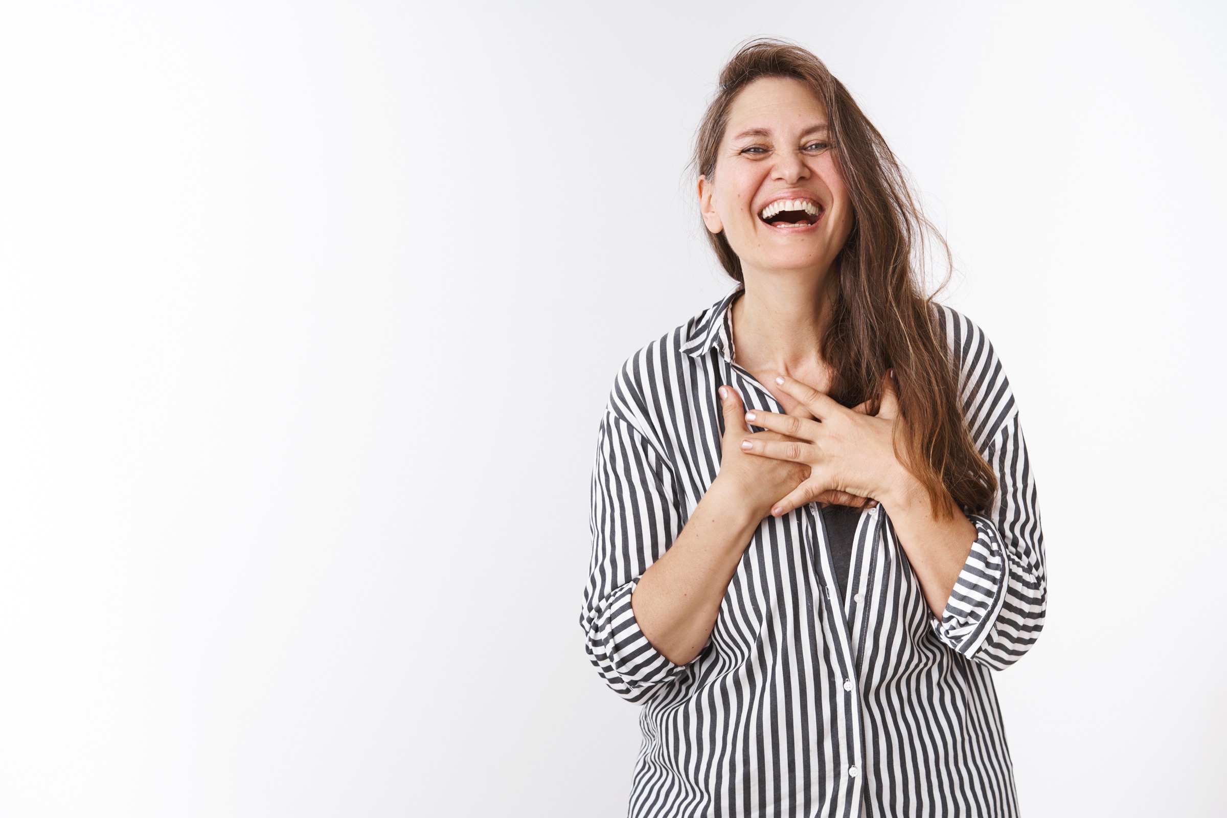 Woman laughing with her hands crossed over her chest
